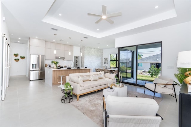 6192 Kambach St, Port Charlotte, FL 33981 - living area with a tray ceiling, a ceiling fan, recessed lighting, and light tile patterned floors