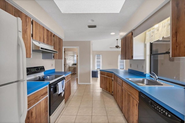 kitchen featuring white appliances, sink, ceiling fan, light tile patterned floors, and a textured ceiling