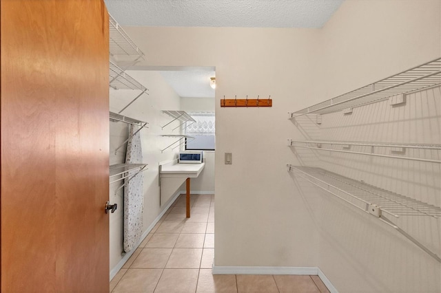 walk in closet featuring light tile patterned flooring