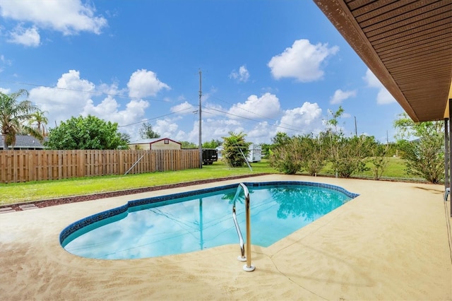 view of swimming pool featuring a patio area and a lawn