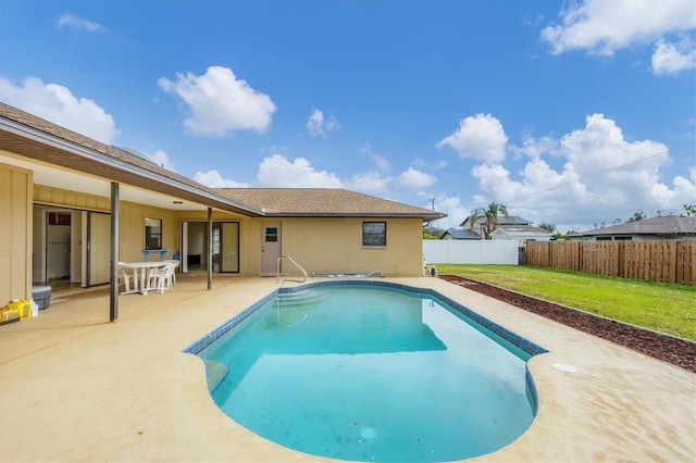 view of swimming pool with a yard and a patio area