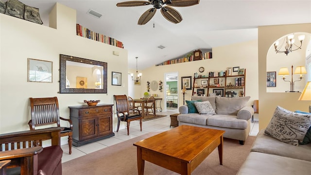 tiled living room featuring ceiling fan with notable chandelier and high vaulted ceiling