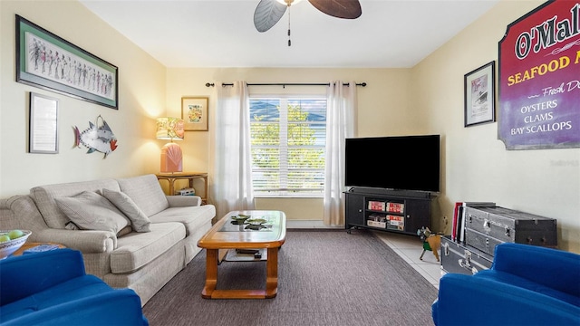 living room featuring ceiling fan and light tile patterned floors