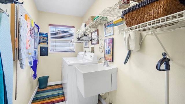 laundry room featuring washing machine and clothes dryer and sink