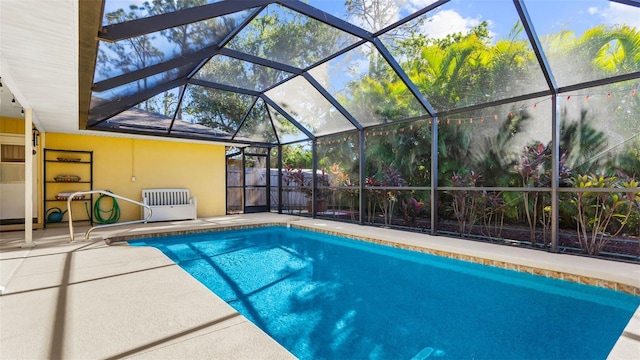 view of pool with a patio area and a lanai