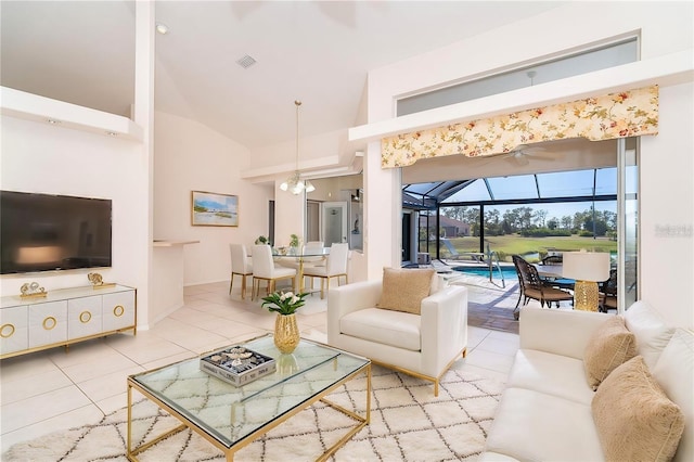 living room with tile patterned floors and high vaulted ceiling