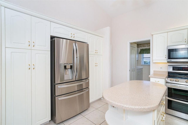 kitchen featuring white cabinets, appliances with stainless steel finishes, and light tile patterned floors