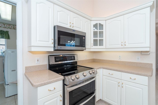 kitchen featuring white cabinetry and appliances with stainless steel finishes