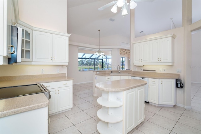 kitchen with kitchen peninsula, white dishwasher, ceiling fan, decorative light fixtures, and white cabinets