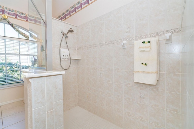 bathroom with tile patterned floors and tiled shower