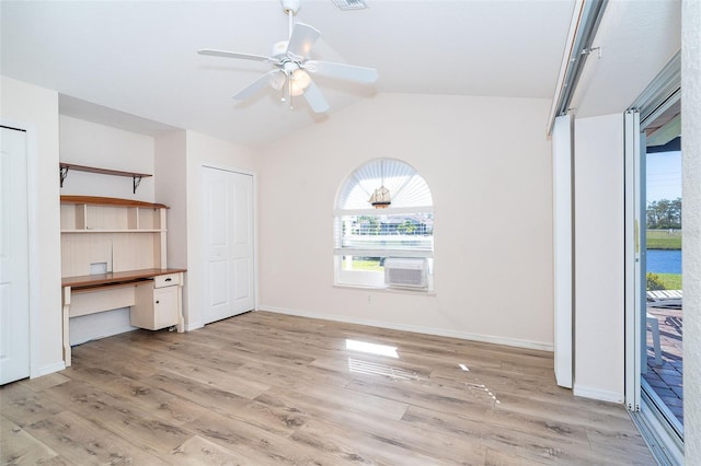 unfurnished bedroom featuring ceiling fan, light wood-type flooring, and vaulted ceiling