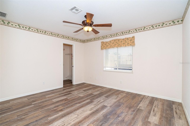 spare room with ceiling fan and hardwood / wood-style flooring