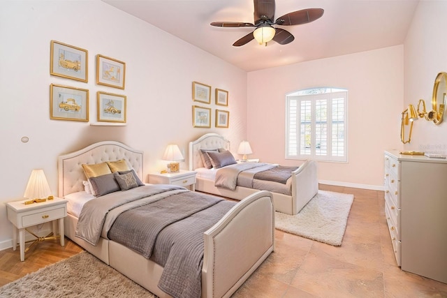 bedroom with ceiling fan and light hardwood / wood-style floors