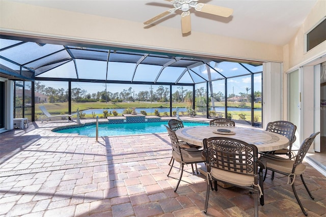 view of swimming pool featuring a patio, a water view, glass enclosure, and ceiling fan