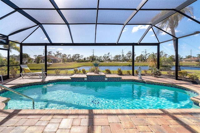 view of pool with glass enclosure, a patio area, and a water view