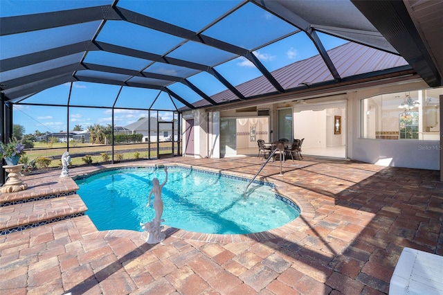 view of swimming pool featuring glass enclosure and a patio