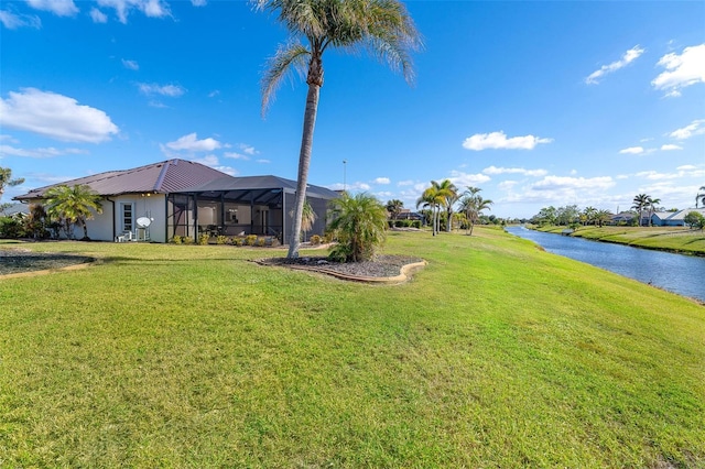 view of yard featuring a water view and a lanai