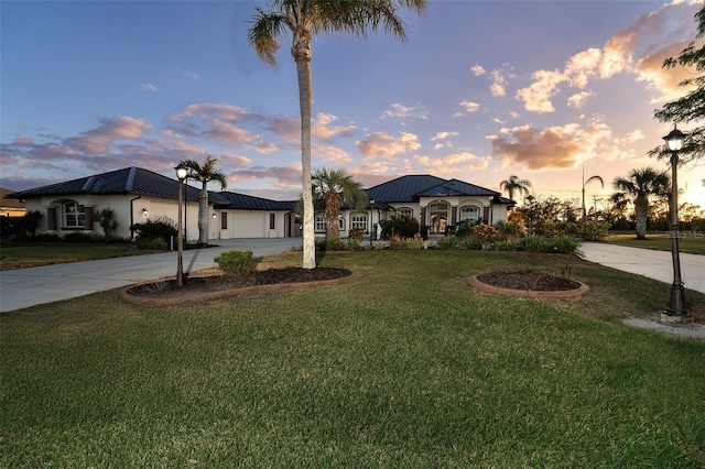 view of front of home featuring a lawn and a garage