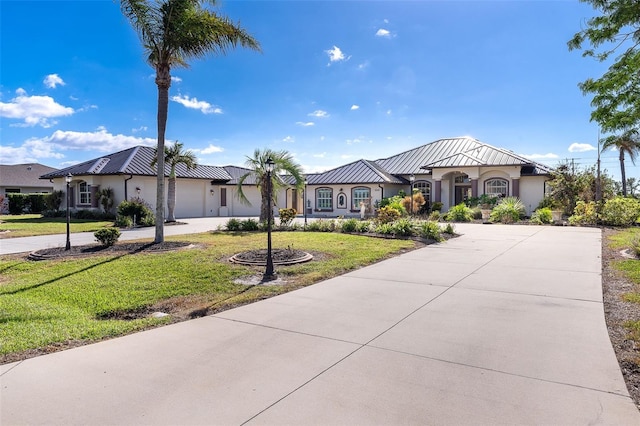646 Boundary Blvd, Rotonda West, FL 33947 - mediterranean / spanish house with an attached garage, stucco siding, a front lawn, and driveway