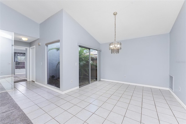 spare room with light tile patterned flooring, high vaulted ceiling, and an inviting chandelier