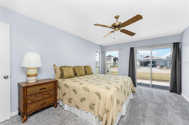 carpeted bedroom featuring ceiling fan, access to outside, and multiple windows