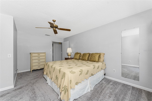 carpeted bedroom featuring a textured ceiling and ceiling fan