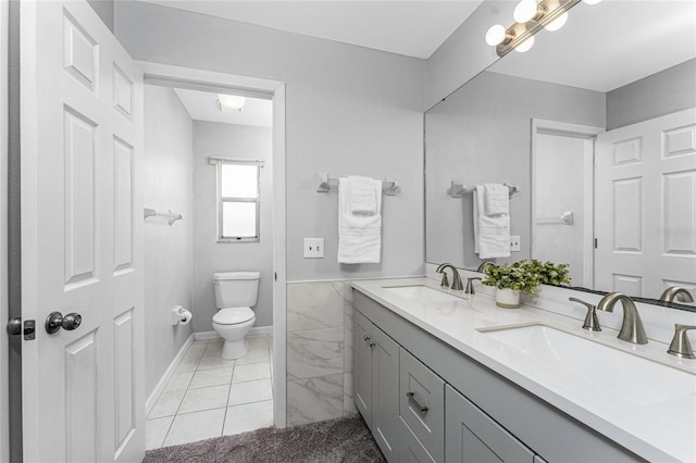 bathroom featuring tile patterned flooring, vanity, and toilet