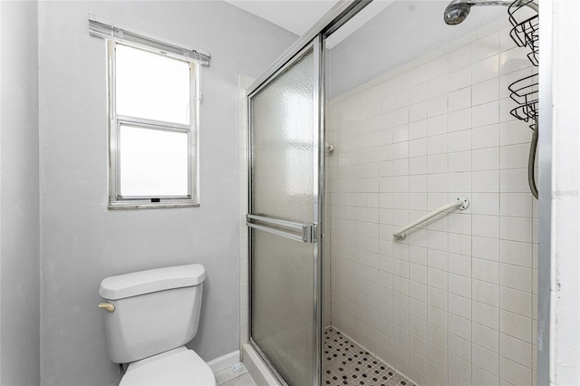 bathroom featuring an enclosed shower and toilet