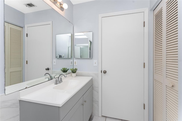 bathroom with tile patterned flooring and vanity