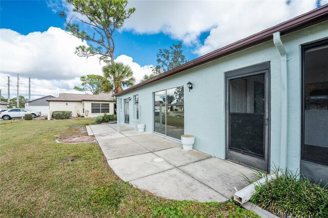 rear view of property with a patio area and a yard