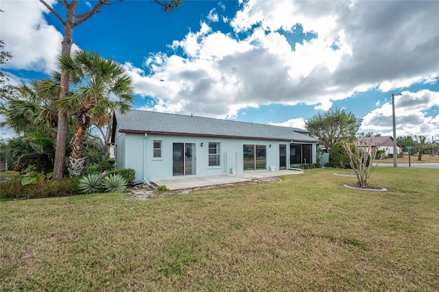 back of house featuring a lawn and a patio