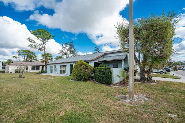 ranch-style home with a front lawn