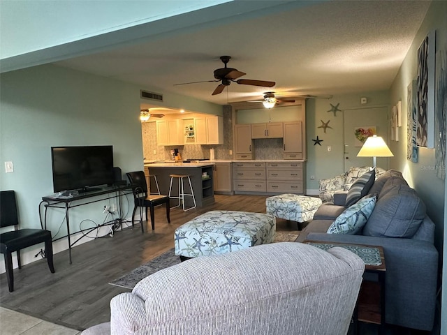 living room featuring ceiling fan and light hardwood / wood-style floors