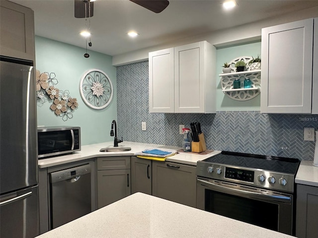 kitchen with gray cabinetry, white cabinets, sink, tasteful backsplash, and stainless steel appliances