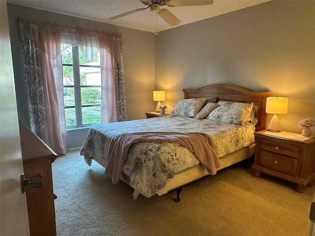 carpeted bedroom featuring multiple windows and ceiling fan