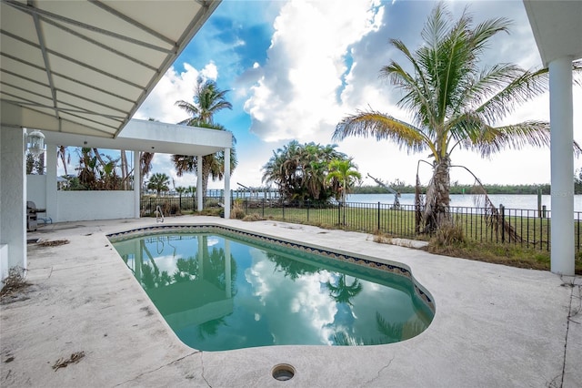 view of pool featuring a water view and a patio