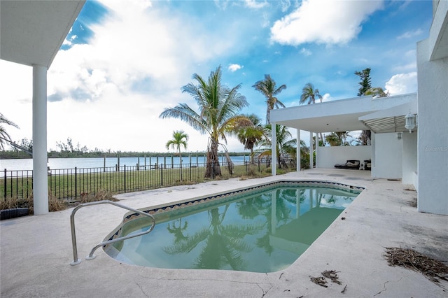 view of pool featuring a water view and a patio area