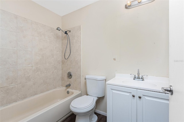 full bathroom with vanity, tiled shower / bath combo, and toilet