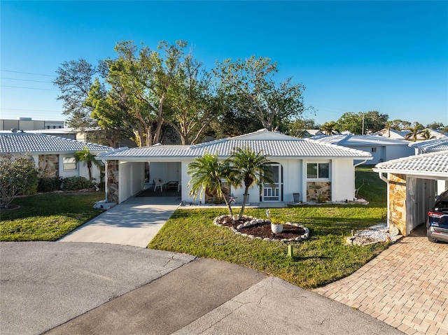 single story home featuring a front lawn and a carport