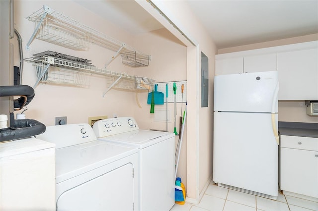 washroom featuring light tile patterned floors, electric panel, and separate washer and dryer