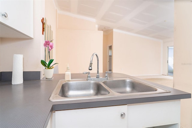 kitchen with white cabinetry and sink