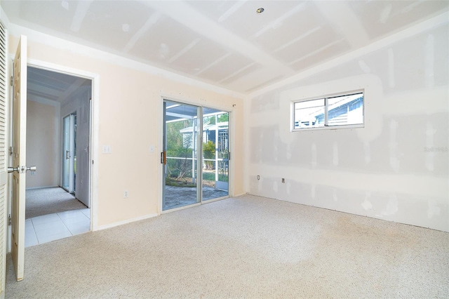 unfurnished room with light colored carpet and lofted ceiling