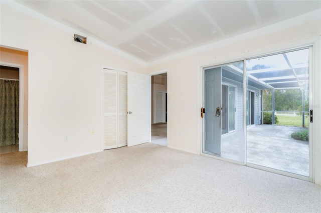 unfurnished room with light carpet and vaulted ceiling