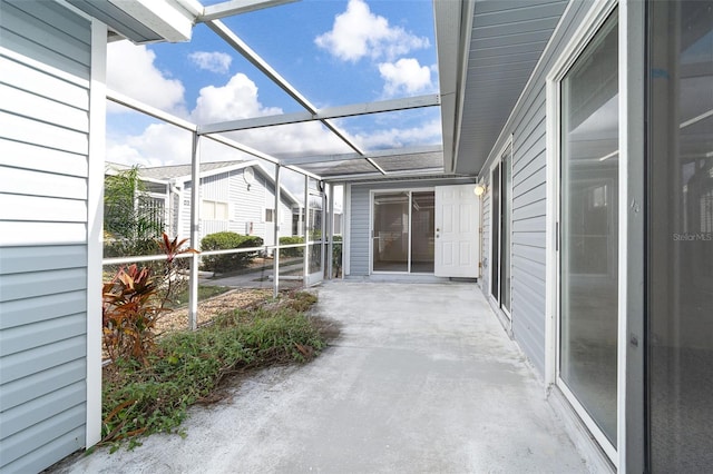 view of patio featuring a lanai