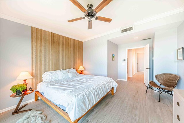 bedroom featuring ceiling fan, crown molding, and light wood-type flooring