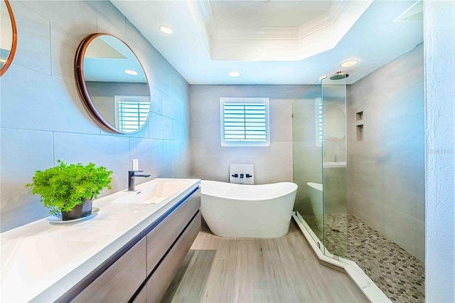 bathroom featuring vanity, crown molding, tile walls, independent shower and bath, and a tray ceiling