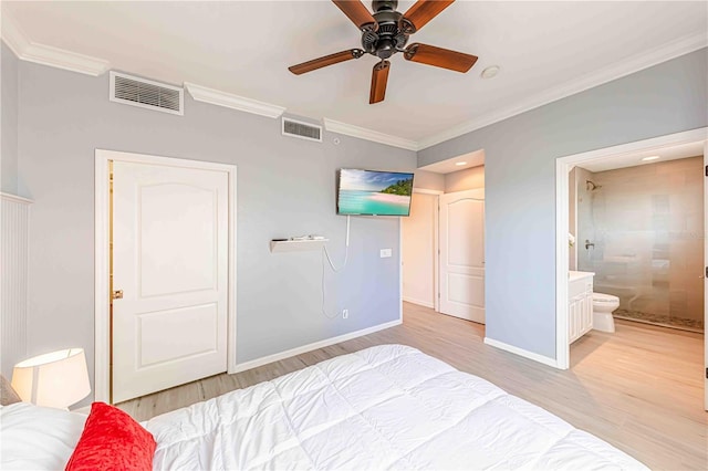 bedroom featuring connected bathroom, light hardwood / wood-style flooring, ceiling fan, and crown molding