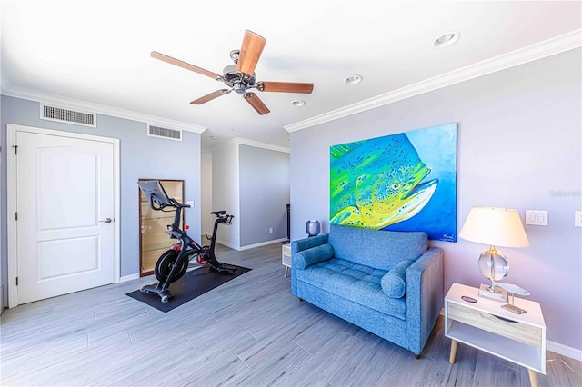 living area featuring ceiling fan, ornamental molding, and hardwood / wood-style flooring