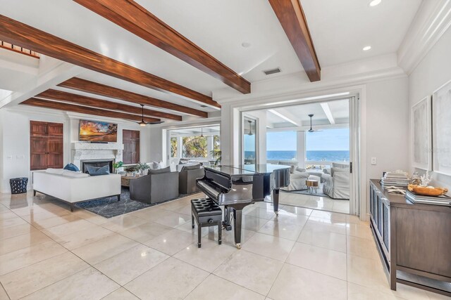 tiled living room with beamed ceiling, a fireplace, and ceiling fan