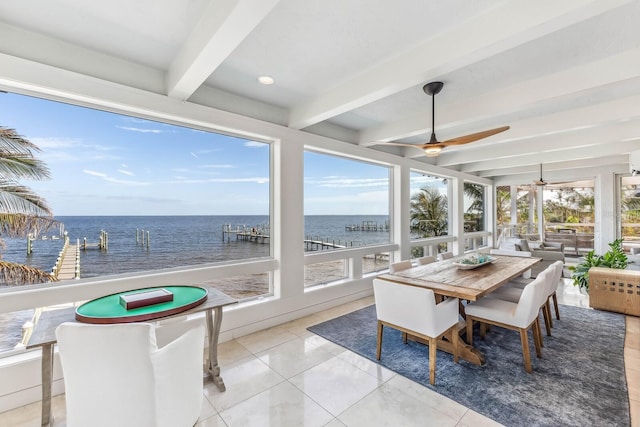 sunroom with beamed ceiling, ceiling fan, a healthy amount of sunlight, and a water view